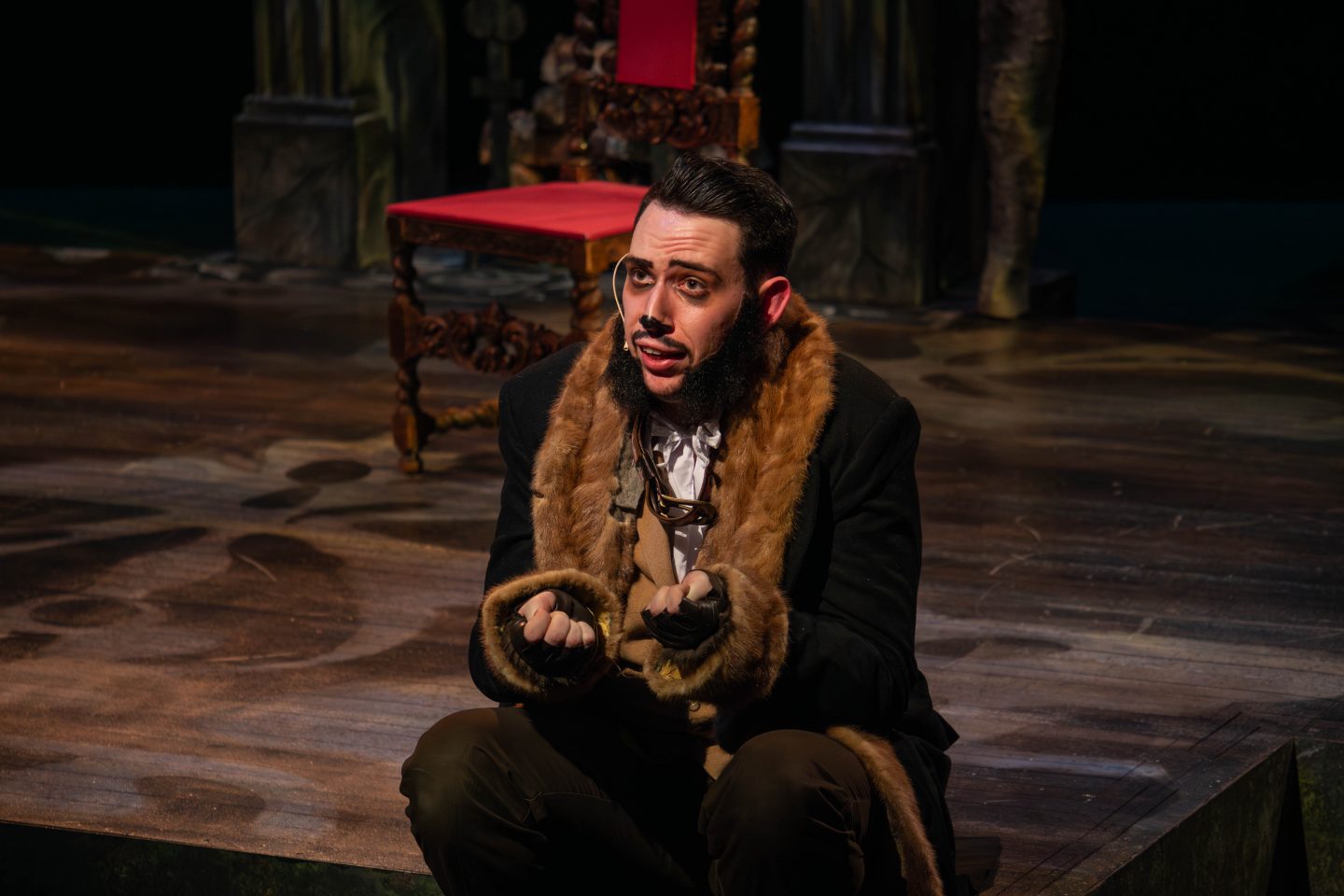 A male student in a scene from a theater stage production of The Moor