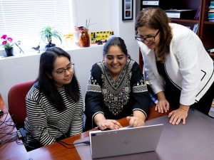 Professor of communication sciences and disorders Reem Khamis, PhD working closely with CSD students