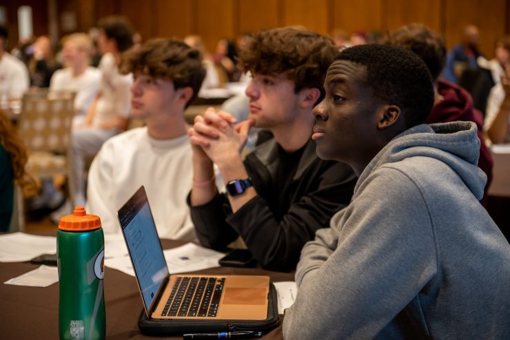 A diverse group of students paying attention during a presentation at Adelphi University - Athletes Helping Athletes