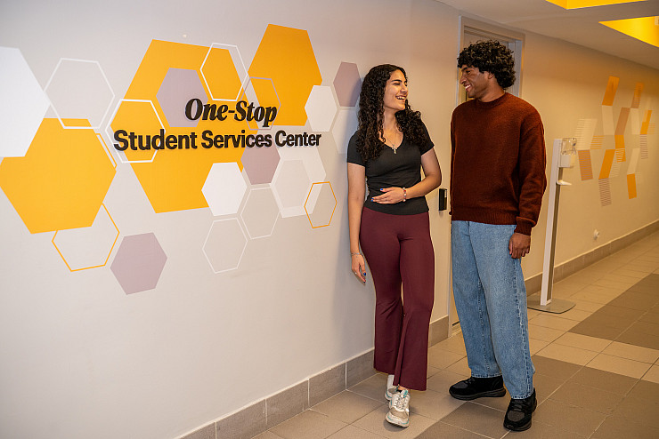 Two students standing at the One Stop Center at Adelphi