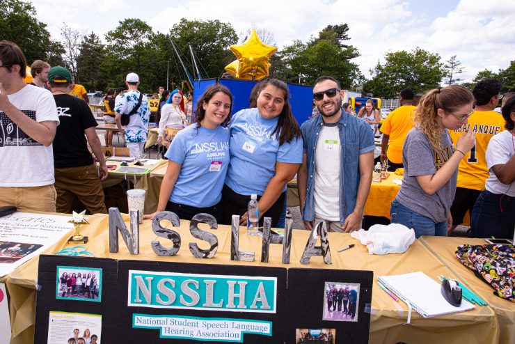 The Adelphi University National Student Speech-Language-Hearing Association (NSSLHA) with a table promoting the organization on campus.