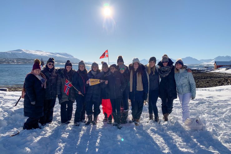 Faculty-Led Trip to Tromsø, Norway, program participants group photo with faculty leaders in Tusseladden Friluftsbarnehage (Kindergarten).