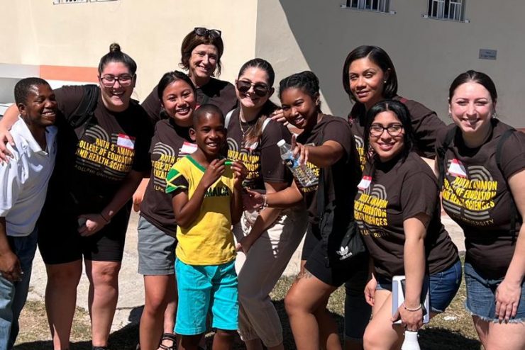 Katarzyna Nowicka, a first-year graduate student in Communication Disorders (Speech Language Pathology), with youngsters in Kingston, Jamaica