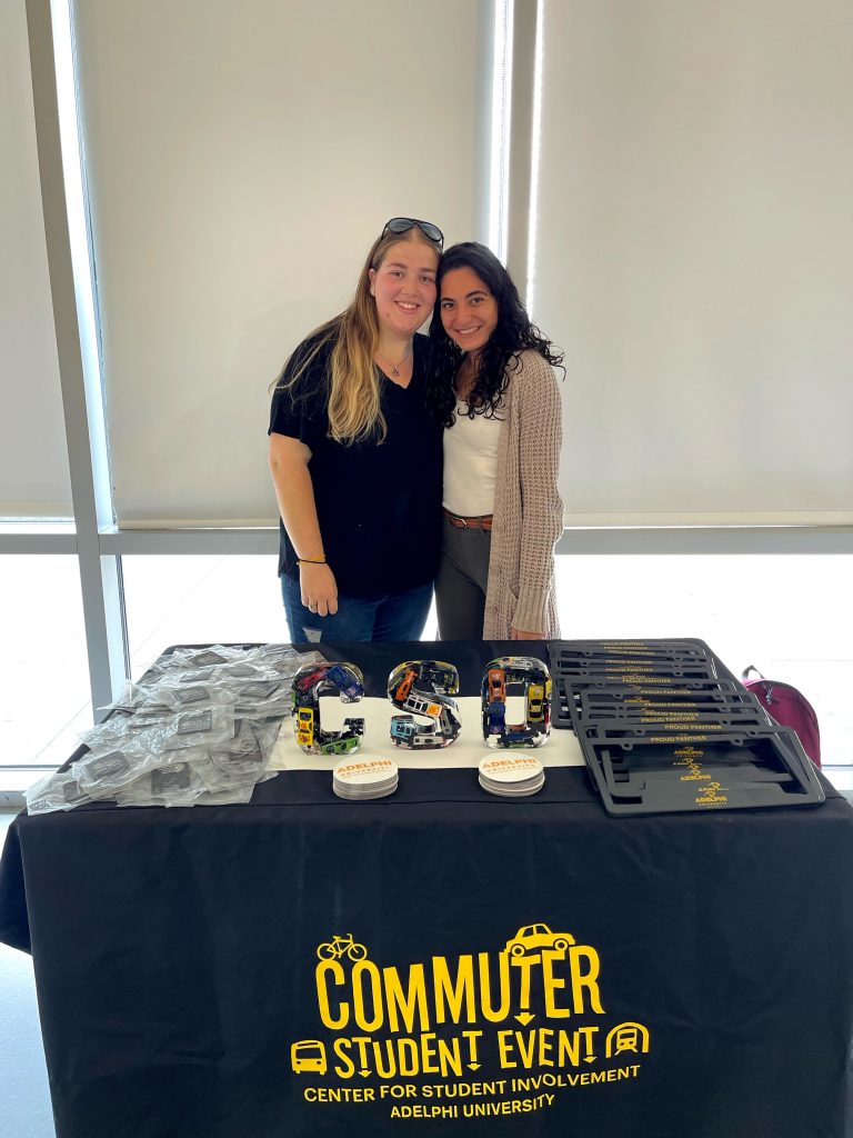 Two CSOs at Adelphi photographed at a table during an event on campus.
