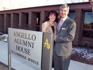 Phyllis and Frank '77 standing in front of the new sign for the Angello Alumni House