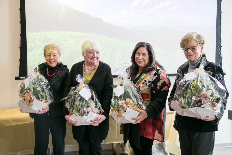 Adelphi Nursing: 40 years of service event where honorees hold flowers