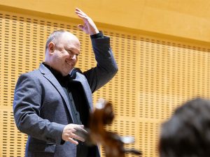 Professor Jordan leads musicians from the podium.