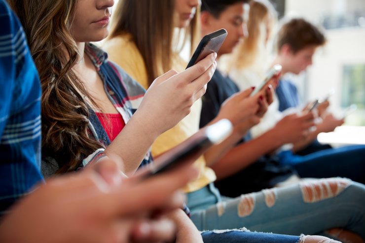 A group of students holding their phones