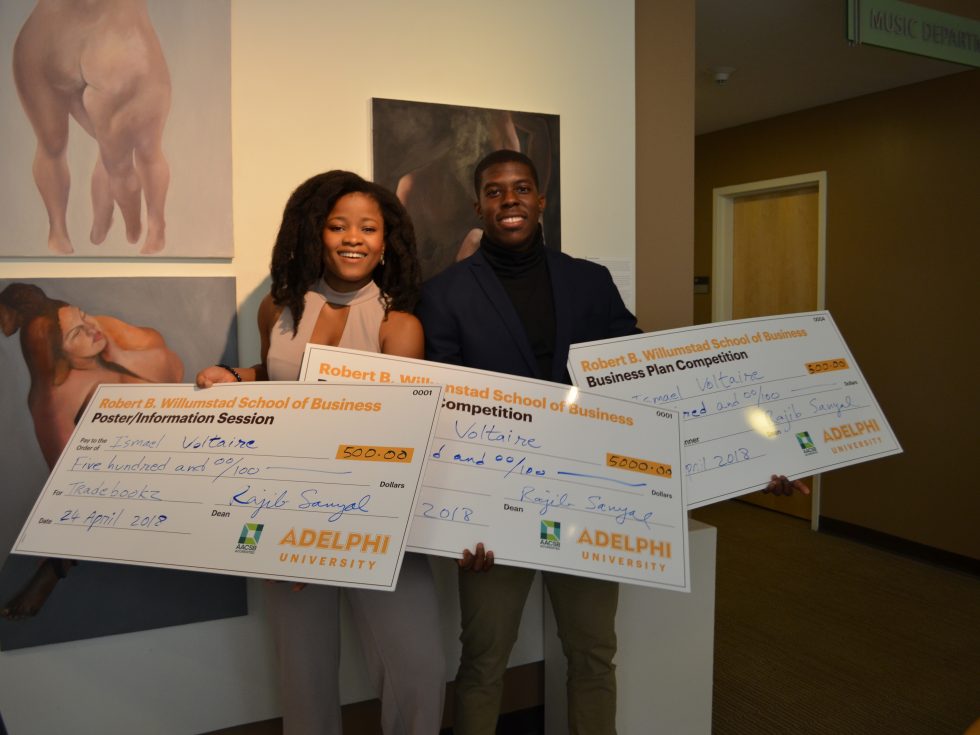 Winners of Adelphi University's first Business Plan Competition holding large checks