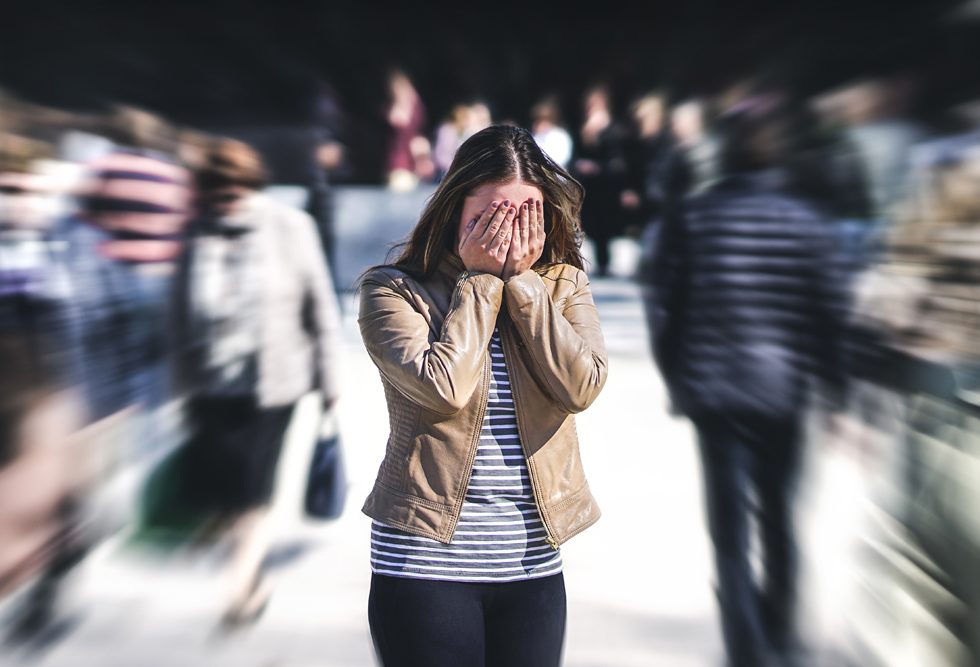 overwhelmed girl in a crowd: concept of anxiety and depression