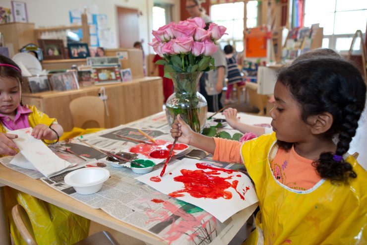 Small child painting at the Alice Brown Early Learning Center on Adelphi's campus.