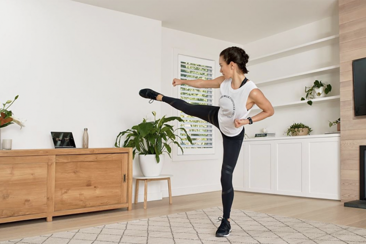 Fitness class in a cozy setting. Kicking up.