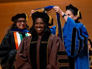 Alicia Wilson, PhD, smiles proAlicia Wilson, PhD ’24, smiles proudly as she receives her doctoral hooding at the May 2024 hooding ceremony at Adelphi.udly as she receives her doctoral hooding at the May 2024 hooding ceremony at Adelphi