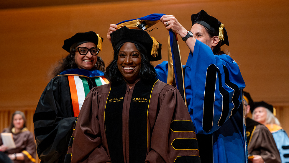 Alicia Wilson, PhD, smiles proAlicia Wilson, PhD ’24, smiles proudly as she receives her doctoral hooding at the May 2024 hooding ceremony at Adelphi.udly as she receives her doctoral hooding at the May 2024 hooding ceremony at Adelphi