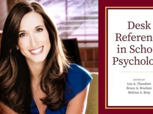 Headshot of woman with long brown hair smiling at camera on left side, on right side, book cover of "Desk Reference in School Reference"