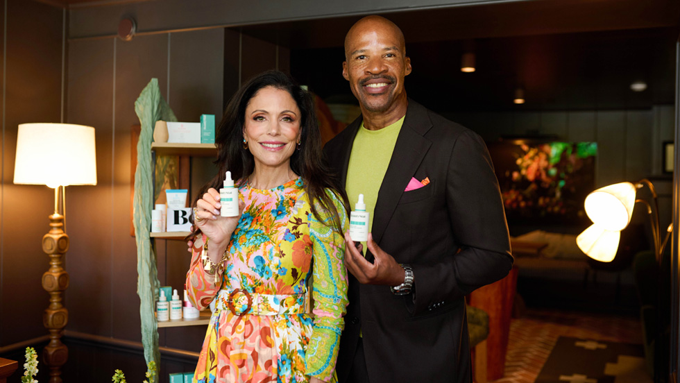 Robinson and Frankel hold bottles of BeautyStat's newest product. They are standing in the luxurious room where the event was held.