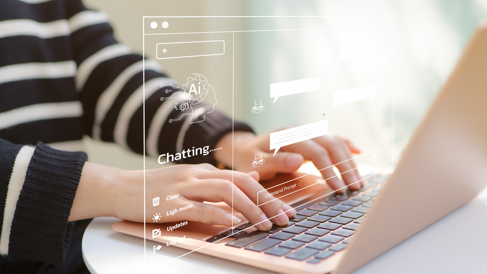 A close-up of a students hands on a laptop's keyboard, overlaid with an image of an AI chatbot search screen.