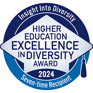 A blue and white badge displaying the Higher Education Excellence in Diversity (HEED) Award in the shape of a graduation cap. The badge reads "Insight Into Diversity - Higher Education Excellence in Diversity Award 2024"