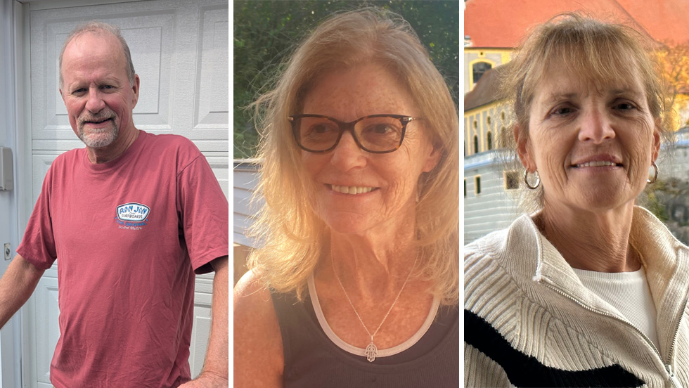 A thin balding man with gray mustache and short beard, a smiling blonde woman with eyeglasses, wearing a necklace and a 2nd smiling woman with short blonde hair and earrings.