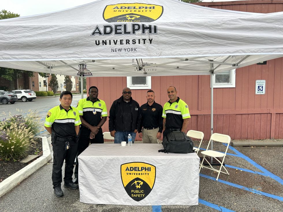 Public Safety Workers standing behind a table outside